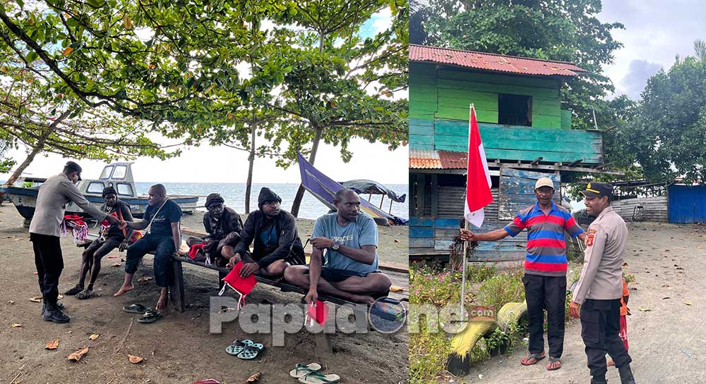 Personel Polda Papua Tengah dengan penuh semangat dan suka cita membagikan bendera merah putih kepada masyarakat sekitar demi